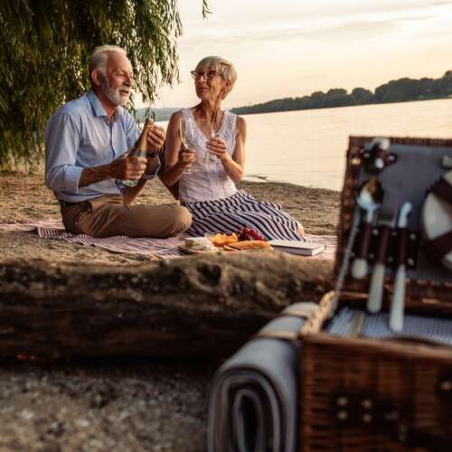 elderly couple on date next to a lake
