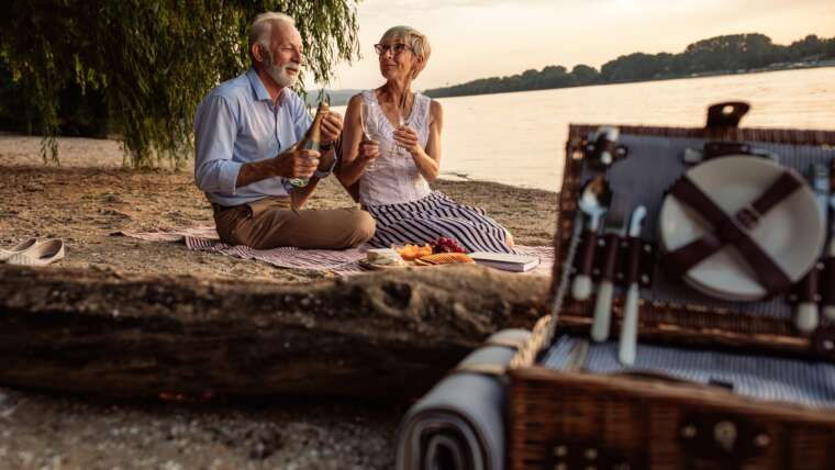 elderly couple on date next to a lake