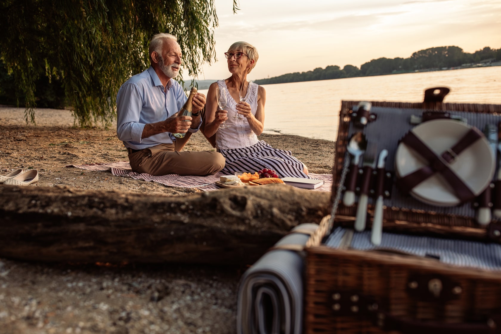 elderly couple on date next to a lake